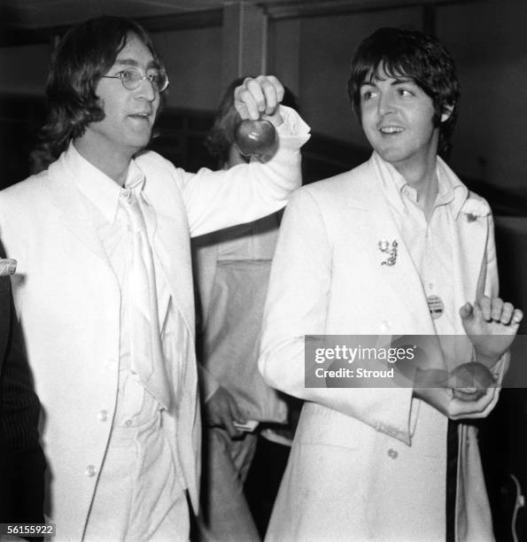 Beatles John Lennon and Paul McCartney at London Airport after a trip to America to promote their new company Apple Corps, 16th May 1968. They are...