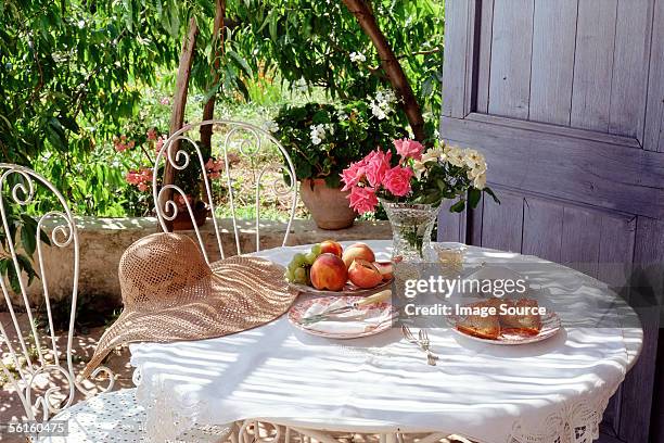 eating in the garden under a peach tree - wine rose stock-fotos und bilder