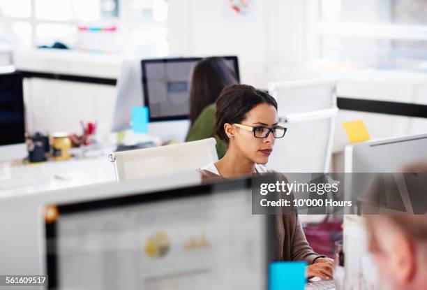 business woman at work station in start-up office - cubicle work stock-fotos und bilder