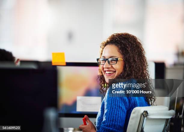 coworkers happily discussing a project in office - happy workers office stock pictures, royalty-free photos & images