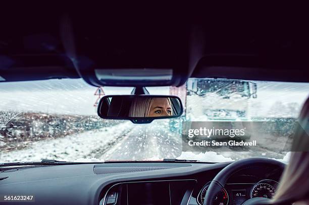 woman driving car in snow - snow uk stock pictures, royalty-free photos & images