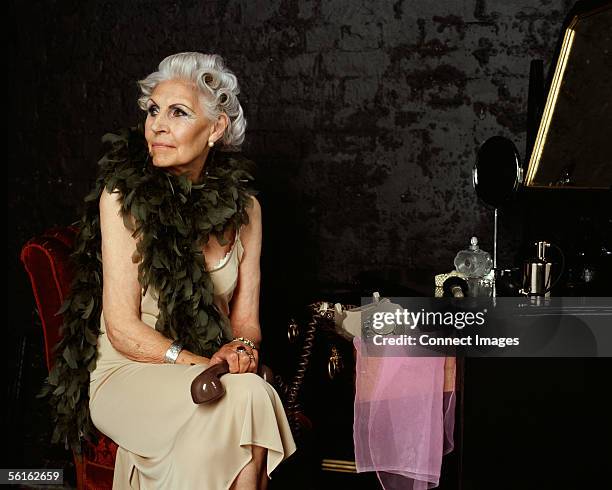 senior woman holding telephone handset - dressing table stock pictures, royalty-free photos & images