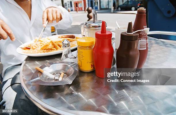 young man eating a fried breakfast - condiment stock pictures, royalty-free photos & images