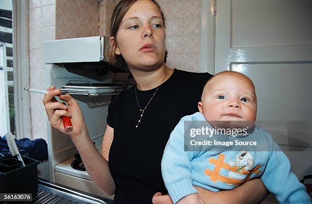 woman smoking near baby - babies and smoking stock-fotos und bilder