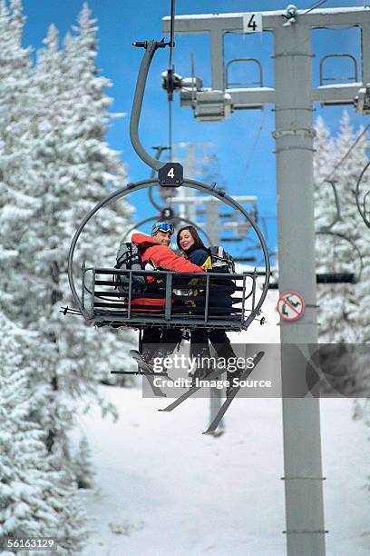 couple on a ski lift - couple ski lift stockfoto's en -beelden