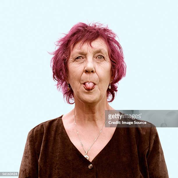 portrait of a senior woman - sticking out tongue stock pictures, royalty-free photos & images