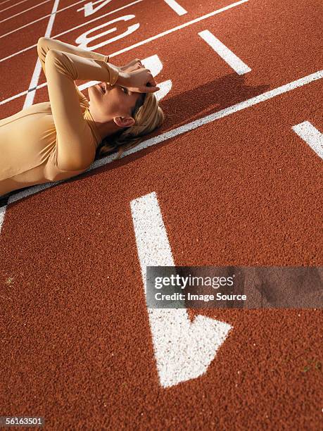 female sprinter on finish line - exhausted at finish line stock pictures, royalty-free photos & images