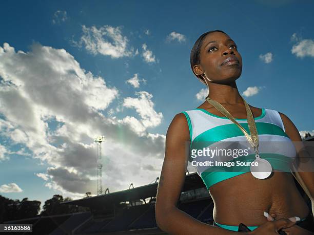 female athlete wearing a medal - sportsperson medal stock pictures, royalty-free photos & images