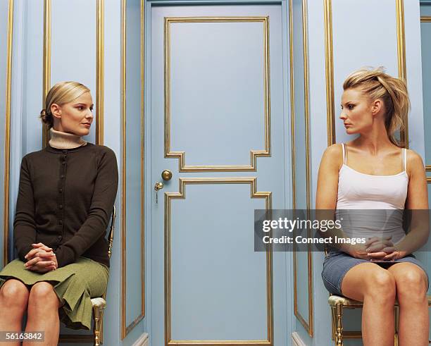 two women on opposite sides of a doorway - envy stock pictures, royalty-free photos & images