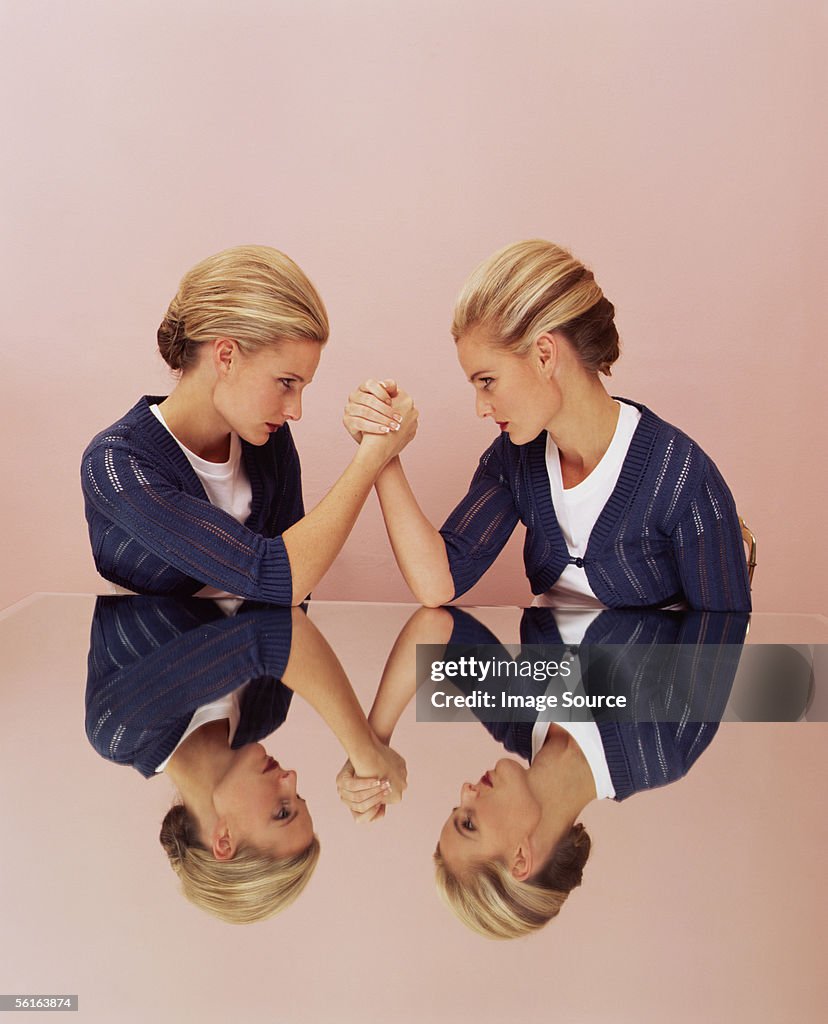 Two women arm wrestling