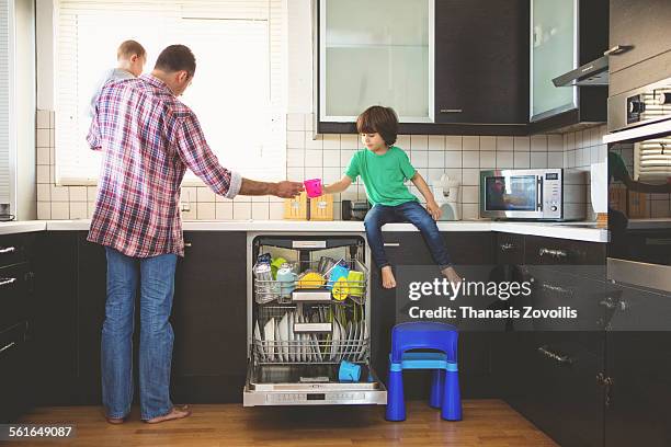 father with his kids - loading dishwasher stock pictures, royalty-free photos & images