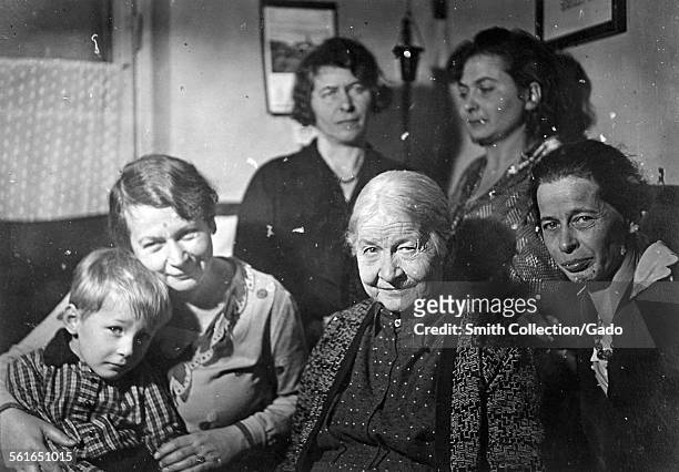 Portrait of a family in a living room, five women and a young boy posing for a family picture, Germany, 1946.