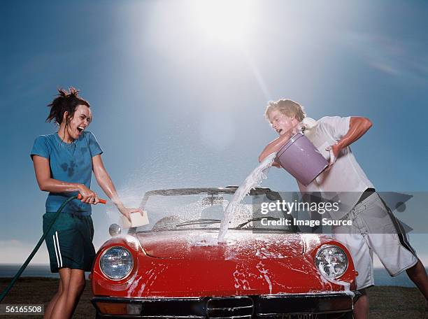 young people washing car - throwing water stock pictures, royalty-free photos & images