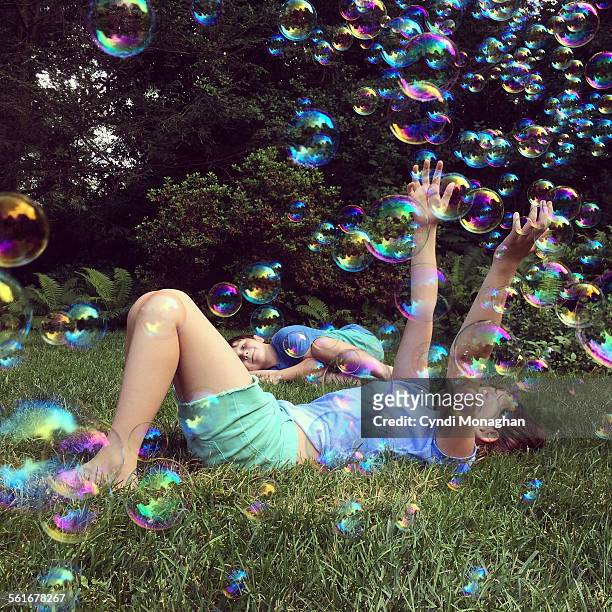 kids playing with bubbles - catching bubbles stock pictures, royalty-free photos & images