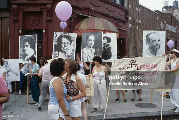 The Duchess bar in the West Village, during the Pride Parade in New York City, June 27, 1982. A banner reads 'In memory of the voices we have lost:...