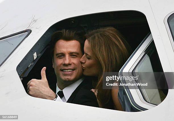 Actor John Travolta is kissed by his wife actress Kelly Preston as they sit in the cockpit of an Airbus A380 at Brisbane International Airport on...