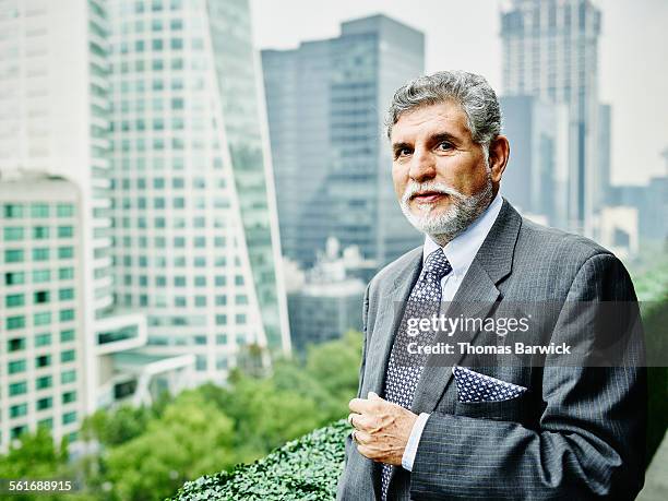 mature business executive standing on office deck - handsome mexican men - fotografias e filmes do acervo