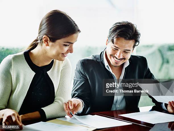 businesswoman and businessman reviewing documents - pact for mexico stock pictures, royalty-free photos & images