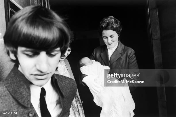 Beatles drummer Ringo Starr leaving Queen Charlotte's Maternity Hospital in Hammersmith with his newborn son, Zak Starkey, 22nd September 1965. Nurse...