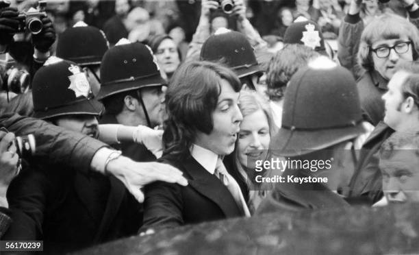 Singer songwriter Paul McCartney and his new wife Linda, nee Eastman, leave Marylebone Registry Office with a police escort after their civil wedding...
