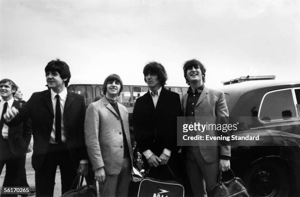 British pop group The Beatles at London Airport on their way to New York to commence their US tour, 13th August 1965. From left to right, Paul...