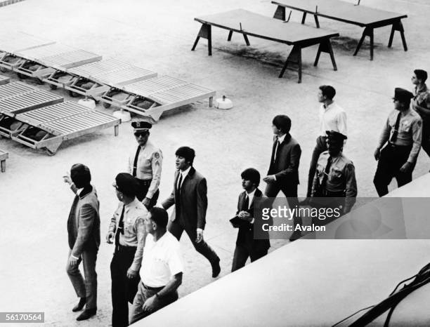 British pop group The Beatles with a police escort at the Deauville Hotel in Miami Beach, Florida, where they perfomed for the Ed Sullivan Show,...
