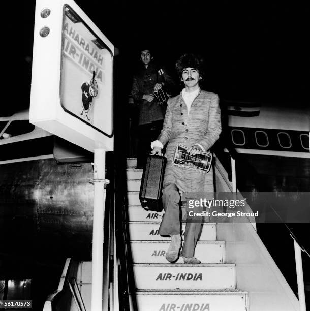 George Harrison of the Beatles arrives at London Airport on an Air India flight, 16th January 1968. He had been in Bombay, producing the soundtrack...
