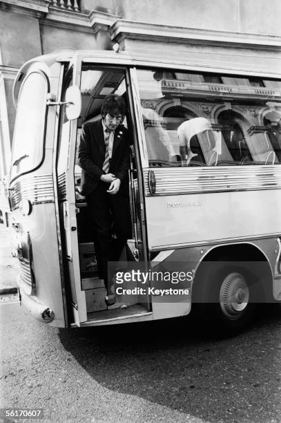 John Lennon of the Beatles leaves the bus in Plymouth during the location filming of 'Magical Mystery Tour', 1967.