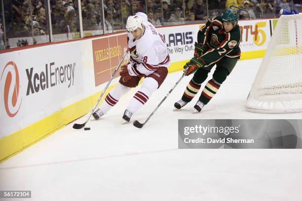 Left wing Mike Leclerc of the Phoenix Coyotes skates with the puck against defenseman Willie Mitchell of the Minnesota Wild at Xcel Energy Center on...