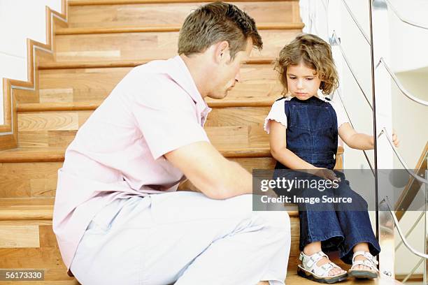 father telling off naughty daughter - regras imagens e fotografias de stock