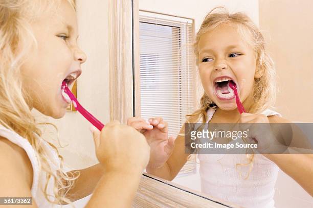 girl brushing teeth - mouth hygiene brush stock pictures, royalty-free photos & images