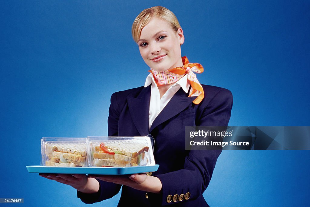 Air hostess holding a tray of sandwiches