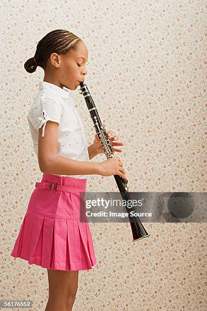 girl playing clarinet - klarinette stock-fotos und bilder