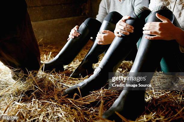 two people wearing riding boots - hay stock pictures, royalty-free photos & images