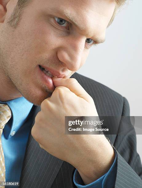 businessman biting his nails - nail biting stock pictures, royalty-free photos & images