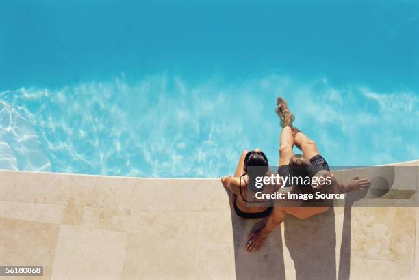 couple by the swimming pool - poolside stock pictures, royalty-free photos & images