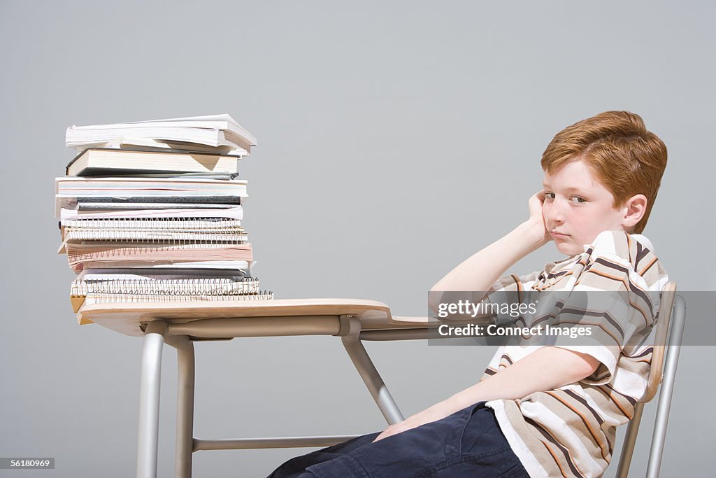 Bored boy sitting at his desk