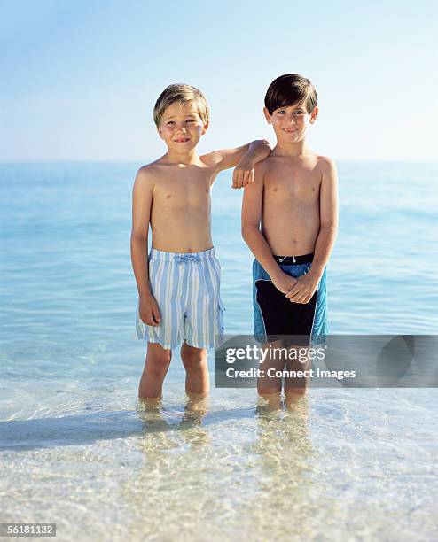 Two Boys Standing In The Sea High-Res Stock Photo - Getty Images