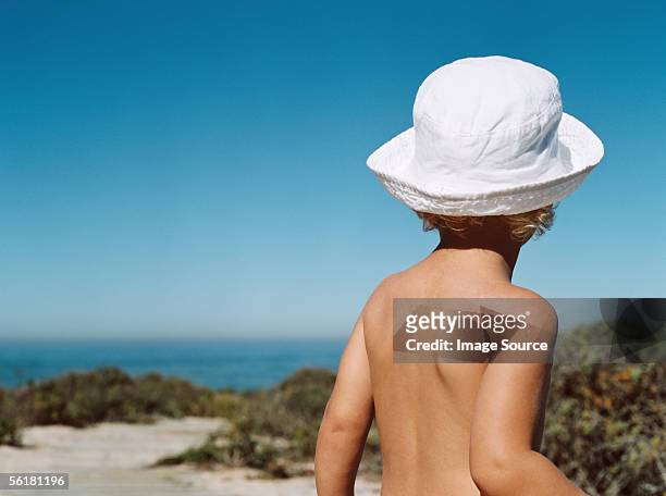 boy at the beach - bucket hat stock pictures, royalty-free photos & images