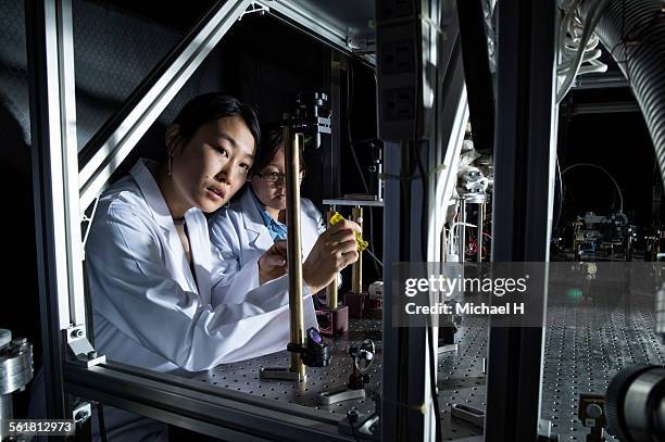 female students examining in science laboratory - groundbreaking female scientists stock-fotos und bilder