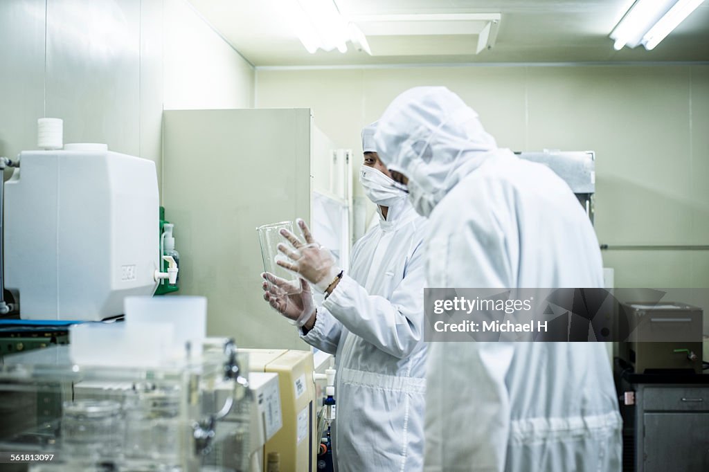 Two research scientists working in clean room