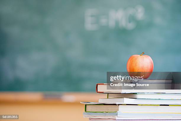 apple in a classroom - text book stockfoto's en -beelden