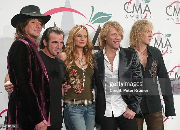 David Bryan, Richie Sambora, Jon Bon Jovi and Tico Torres of rock group Bon Jovi pose with singer Jennifer Nettles of the group Sugarland in the...