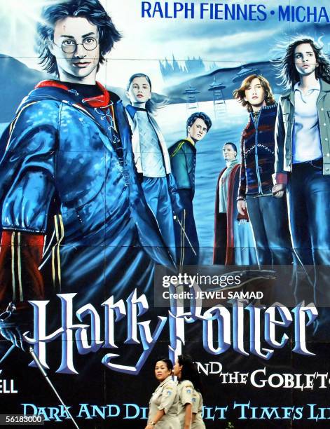 Women walk past a huge billboard of the latest Harry Potter movie, "Harry Potter and the Goblet of Fire," in Jakarta, 16 November 2005. Like three...