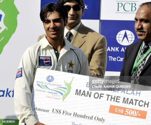 Pakistani batsman Salman Butt receives the man of the match award during the match closing ceremony following Pakistan's victory over England on the...