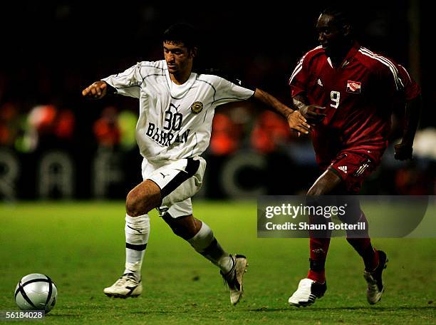 Alaa Ahmed Hubail of Bahrain is challenged by Aurtis Whitley ofTrinidad during the FIFA 2006 World Cup Playoff First Leg match between Trinidad &...