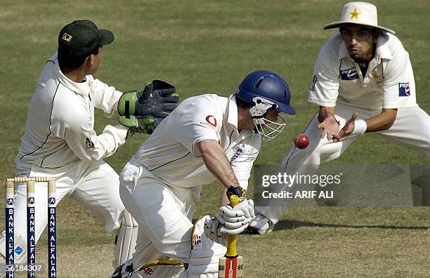 Pakistani cricketer Hasan Raza successfully catches the ball off England batsman Andrew Strauss during the fifth and last day of the first Test match...