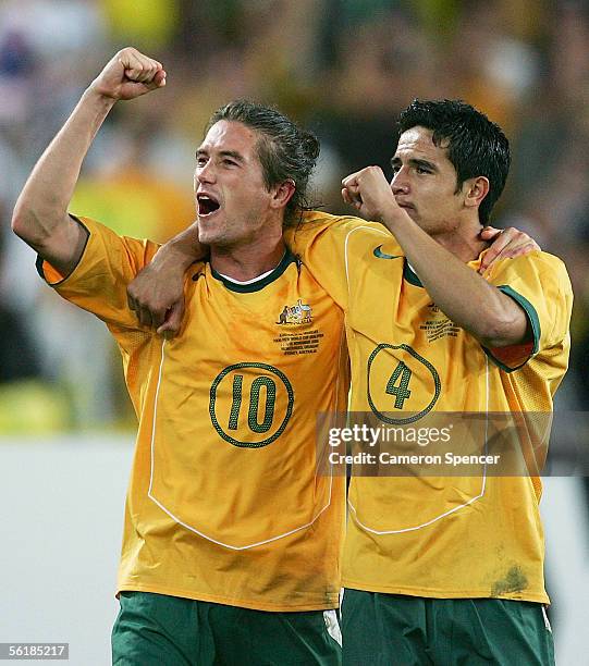 Harry Kewell and Tim Cahill of the Socceroos celebrate victory after the second leg of the 2006 FIFA World Cup qualifying match between Australia and...