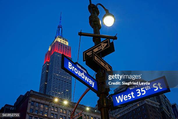 broadway and empire state building - broadway manhattan stock pictures, royalty-free photos & images