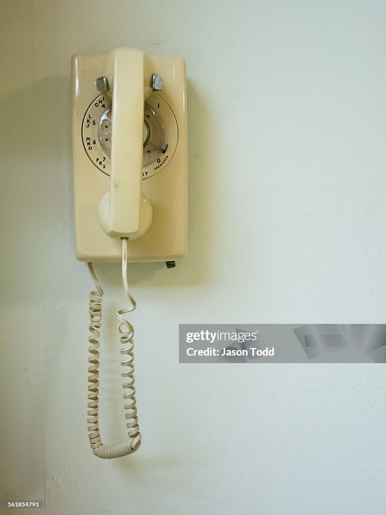 Landline home telephone hanging on wall